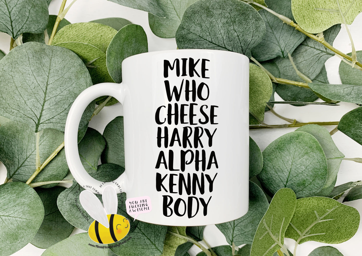 White mug with the quote mike who cheese alpha kenny body printed down the middle in black ink.