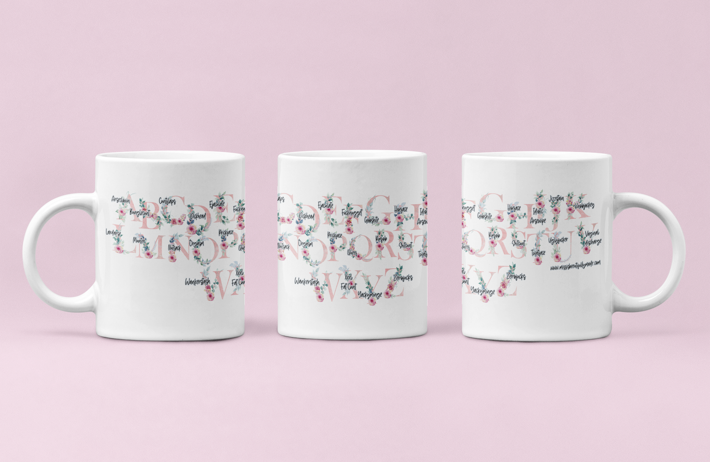 A white ceramic mug featuring a pink floral alphabet design around the whole of the mug. Each letter has a funny profanity word associated to it i.e, a for arseclown, b for bunglecunt.