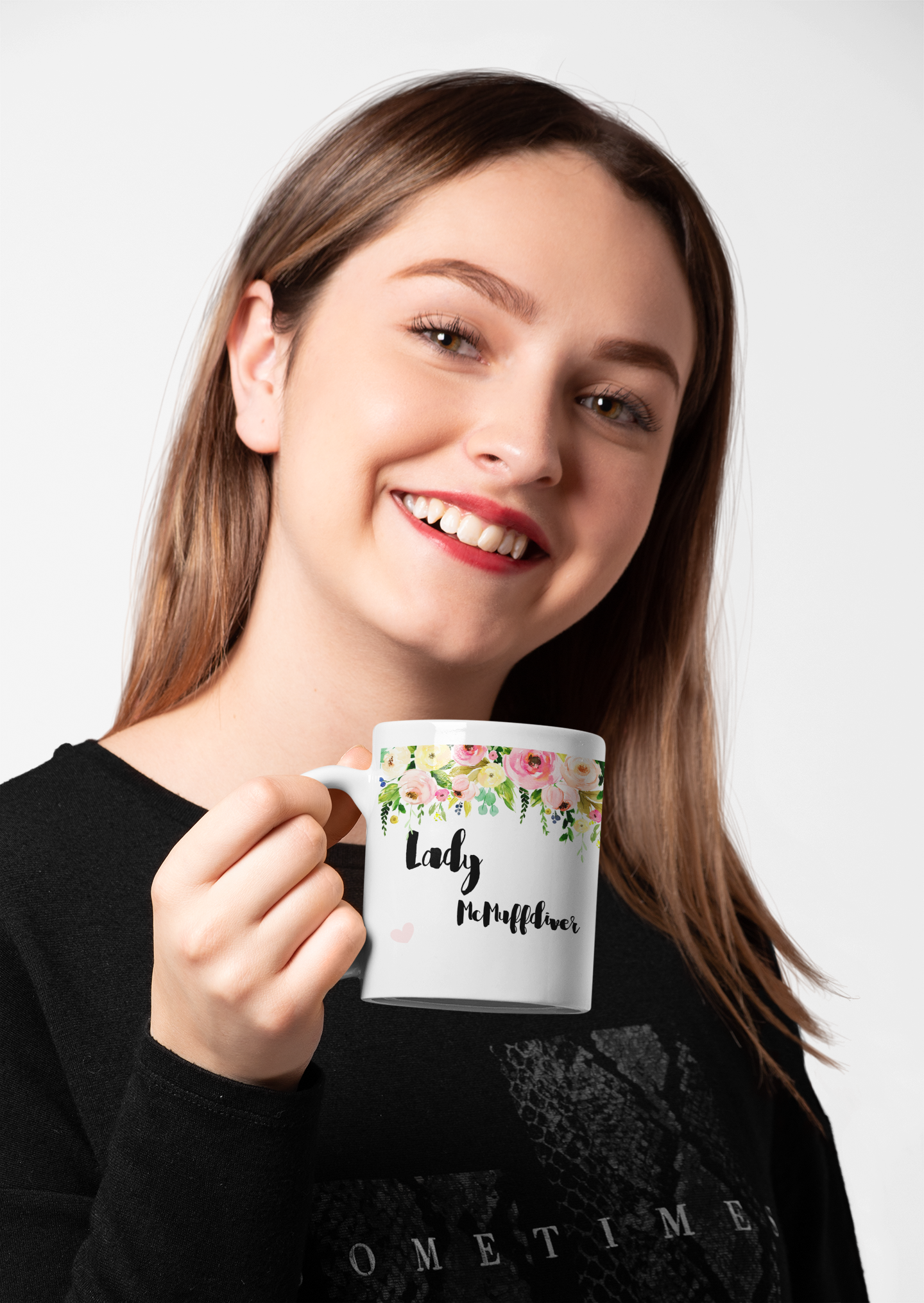 Woman holding a white mug with a colourful floral banner to the top. Under is a quote ' lady mcclitsuckler'.