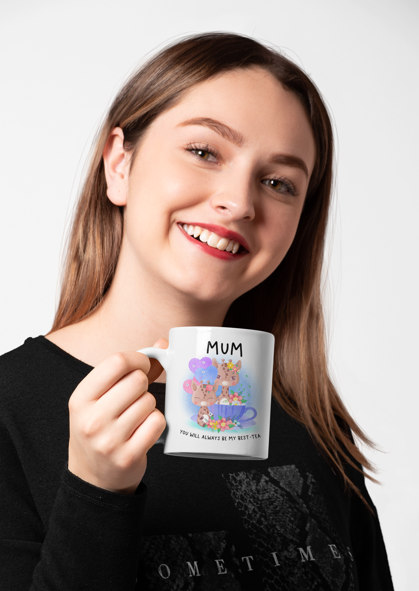 white mug with a pink handle featuring cute pastel colour giraffes sitting in a teacup with the word 'mum' at the top and to the bottom is reads 'you will always be my best-tea'.