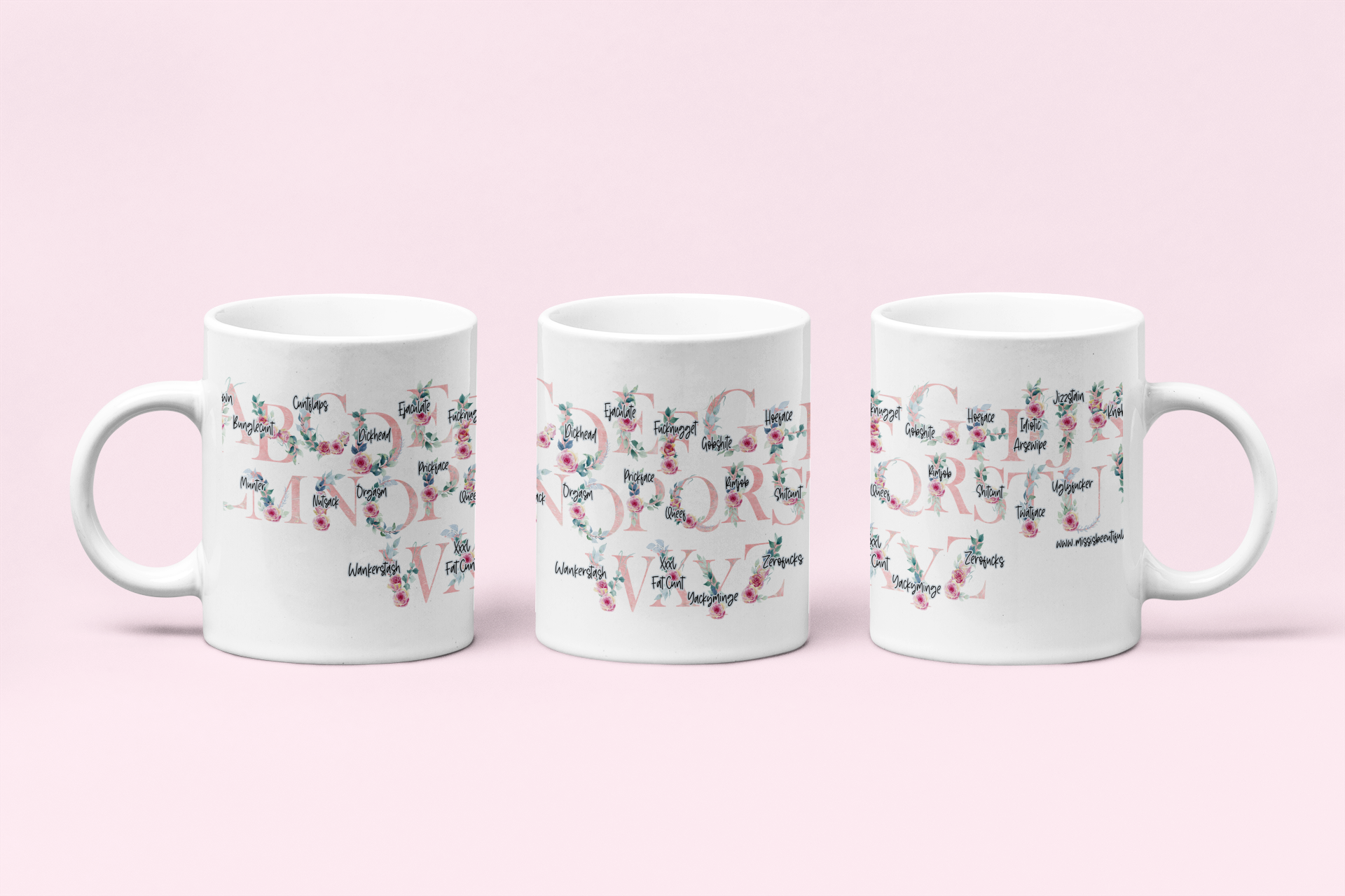 A white ceramic mug featuring a pink floral alphabet design around the whole of the mug. Each letter has a funny profanity word associated to it i.e, a for arseclown, b for bunglecunt.