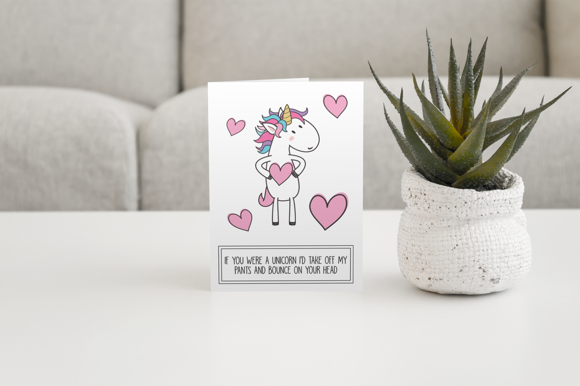 White vertical greetings card featuring a fun unicorn design. To the botton it reads 'if you were a unicorn, i'd take off my pants & bounce on your head'. Printed in black ink.
