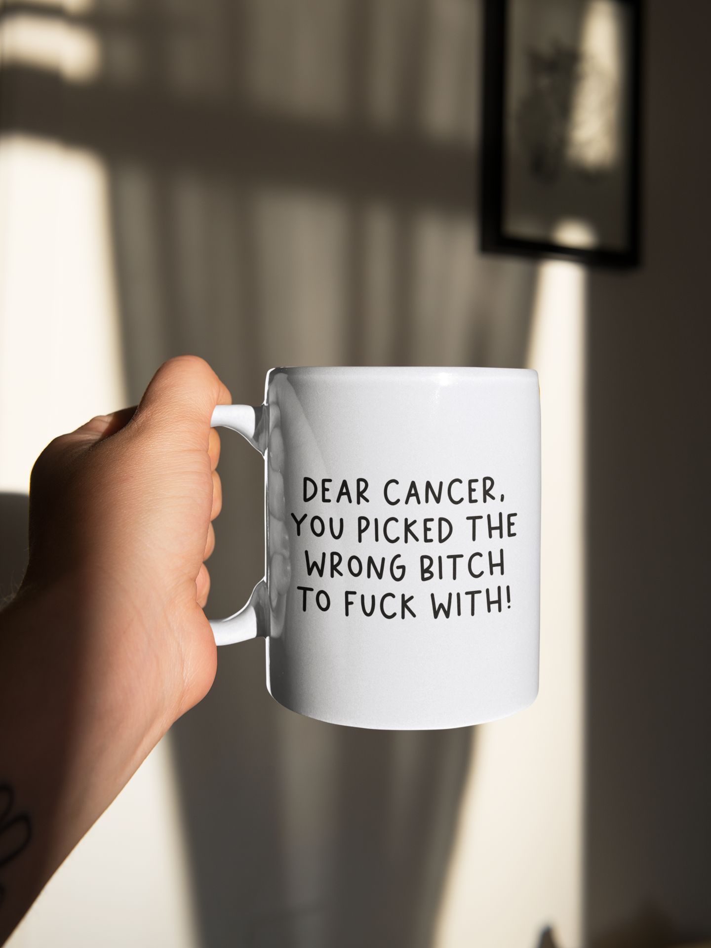 White mug with the quote 'dear cancer, you picked the wrong bitch to fuck with' situated in the middle & printed in black.