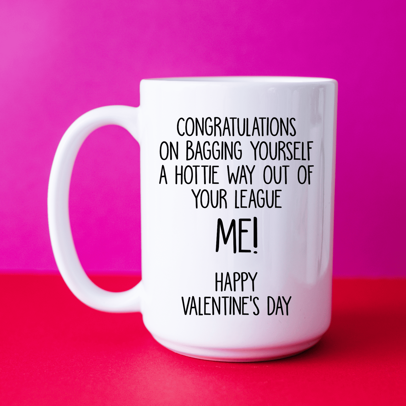 A white mug with the funny quote 'congratulations on bagging yourself a hottie way out of your league... Me!' Printed in black ink.