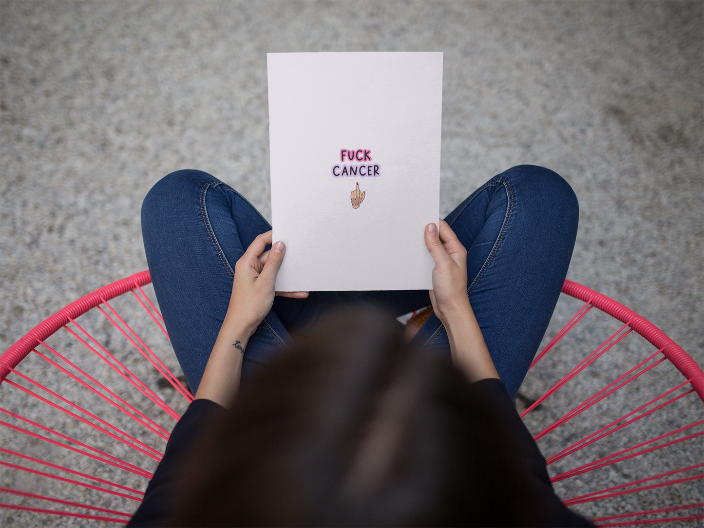 White vertical greetings card with a middle finger clipart in the centre. Above the middle finger design is the words 'fuck cancer', printed in black with a pink & purple outline.