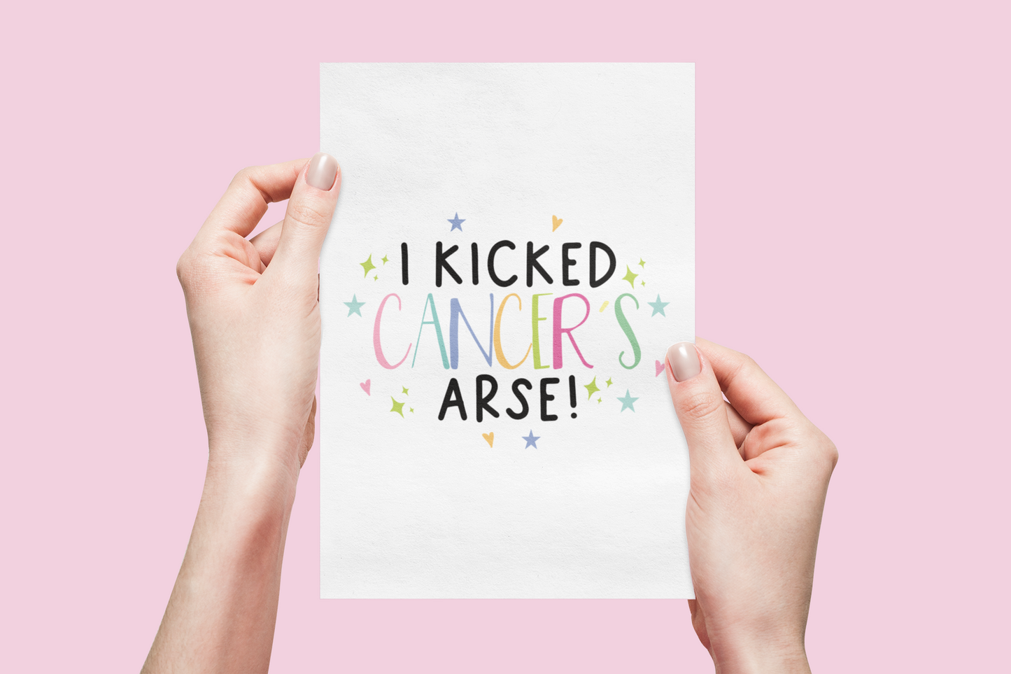 White vertical card with the words 'i kicked cancers arse!' printed in the middle. Cancer is multicoloured pastel colours surrounded by little pastel stars & hearts.