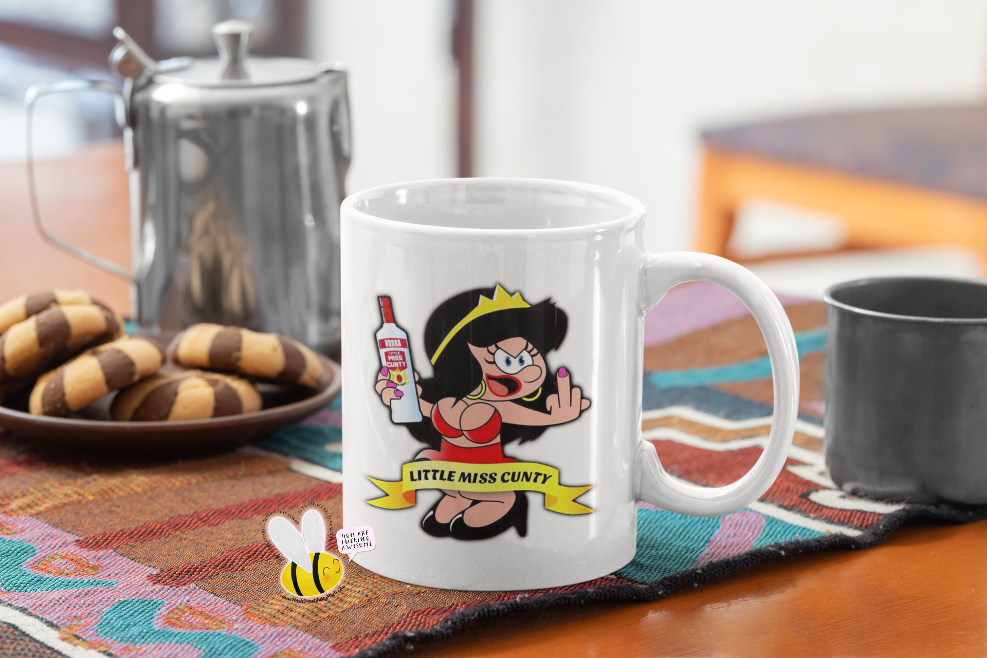 White mug with a design of a cartoon woman sticking her middle finger up & the quote little miss cunty, to the back of the mug it says cunty by name even cuntier by nature.
