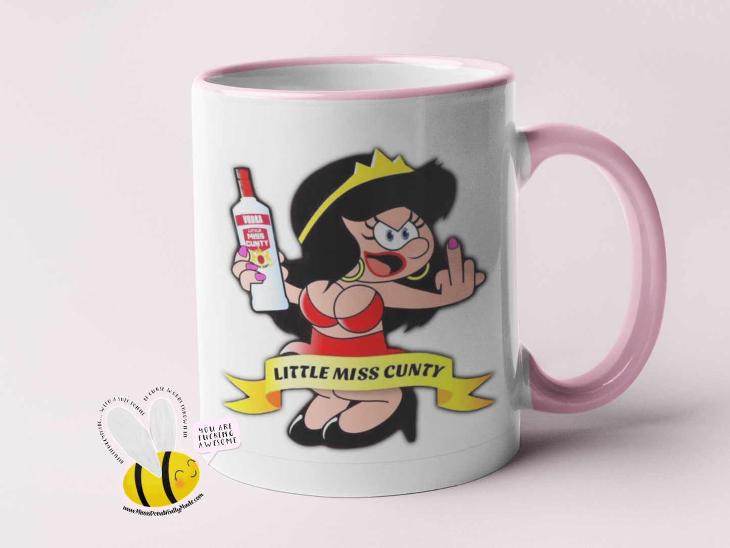 White mug with a design of a cartoon woman sticking her middle finger up & the quote little miss cunty, to the back of the mug it says cunty by name even cuntier by nature.