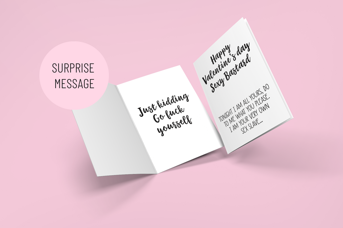 Girls hand holding a white vertical greetings card featuring a fun quote to the front 'happy Valentine's Day you sexy bastard' & a sex slave quote underneath. Printed in black ink.