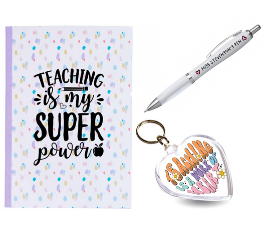 A teachers gift bundle which includes a notebook, a pen and a heart shape keyring, all containing motivational teaching quotes.