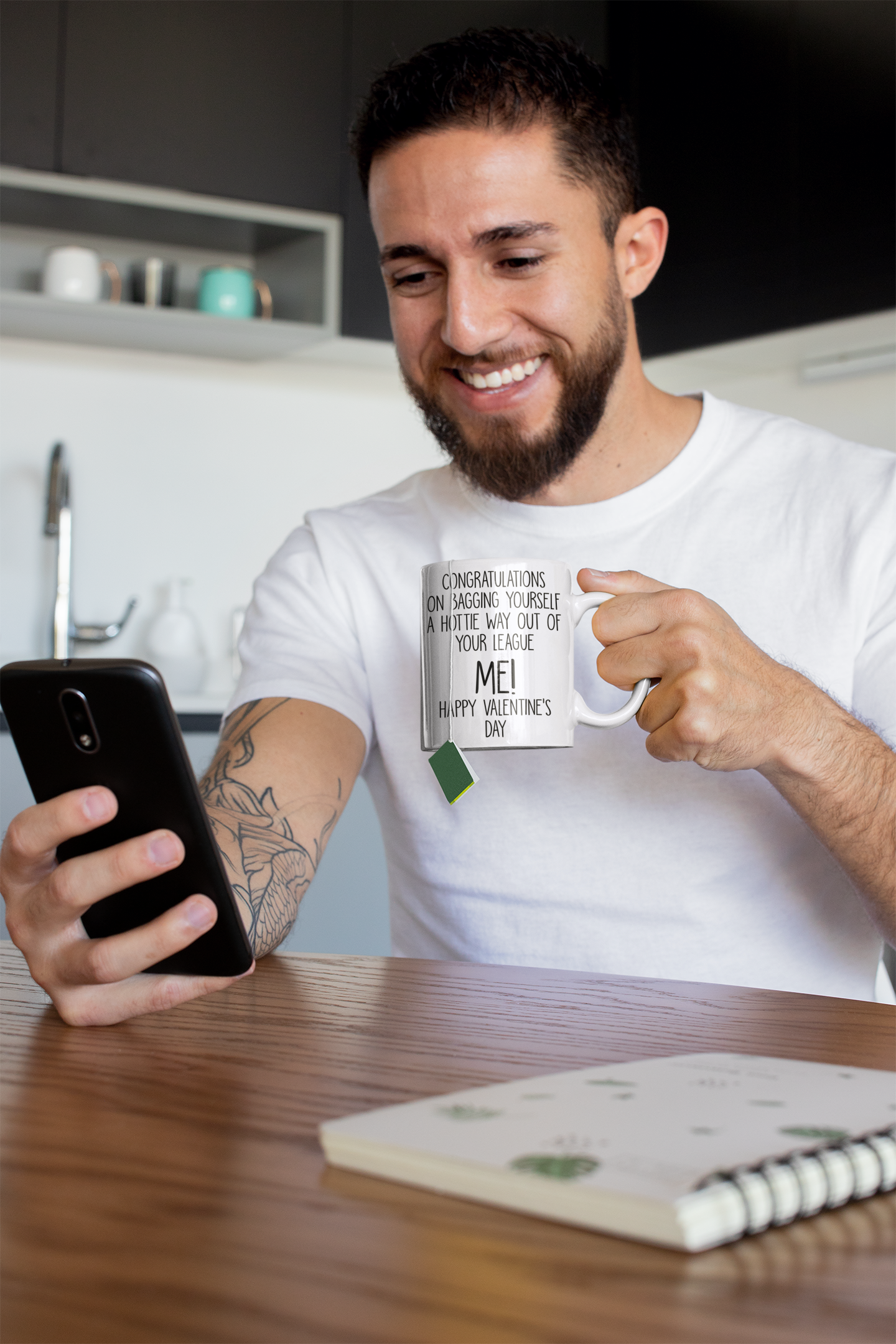 A white mug with the funny quote 'congratulations on bagging yourself a hottie way out of your league... Me!' Printed in black ink.