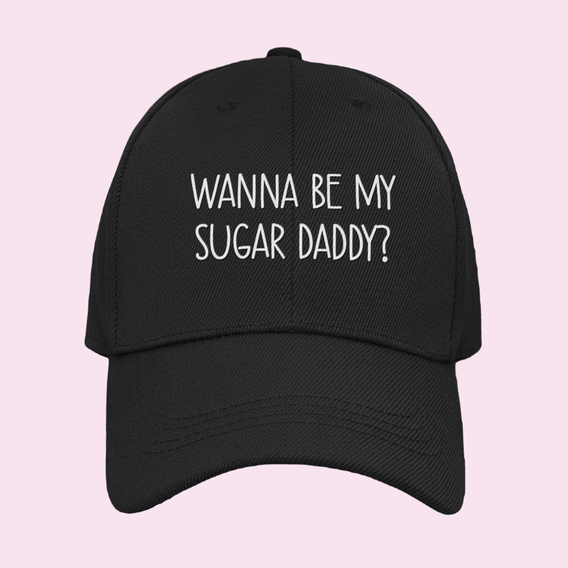A black cotton cap with white lettering to the front which reads 'wanna be my sugar daddy?'.