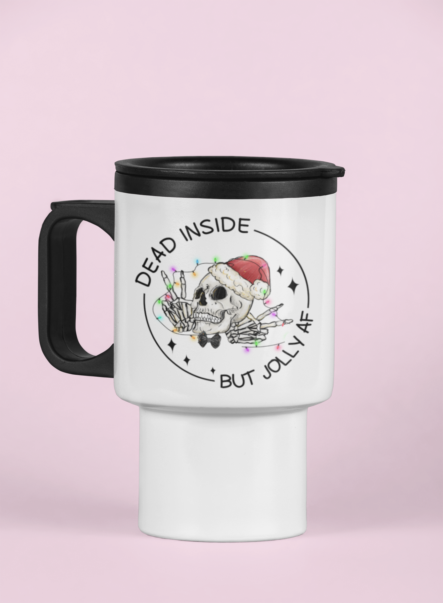 White travel mug with a black handle & black lid featuring a fun christmas skull design with the words dead inside but jolly as fuck. Printed in black ink.