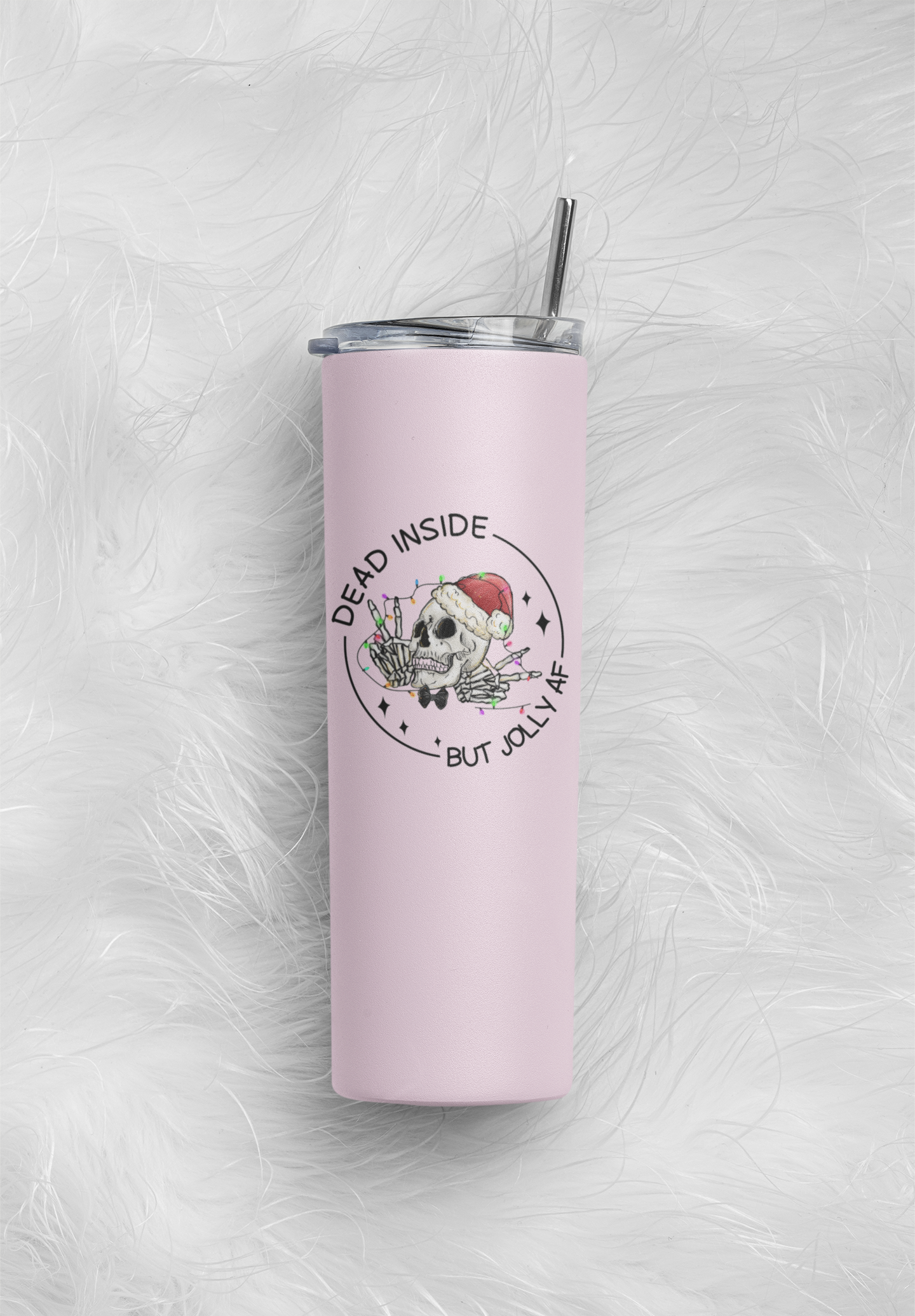 Pink skinny tumbler featuring a fun christmas skull design with the words dead inside but jolly as fuck. Printed in black ink.