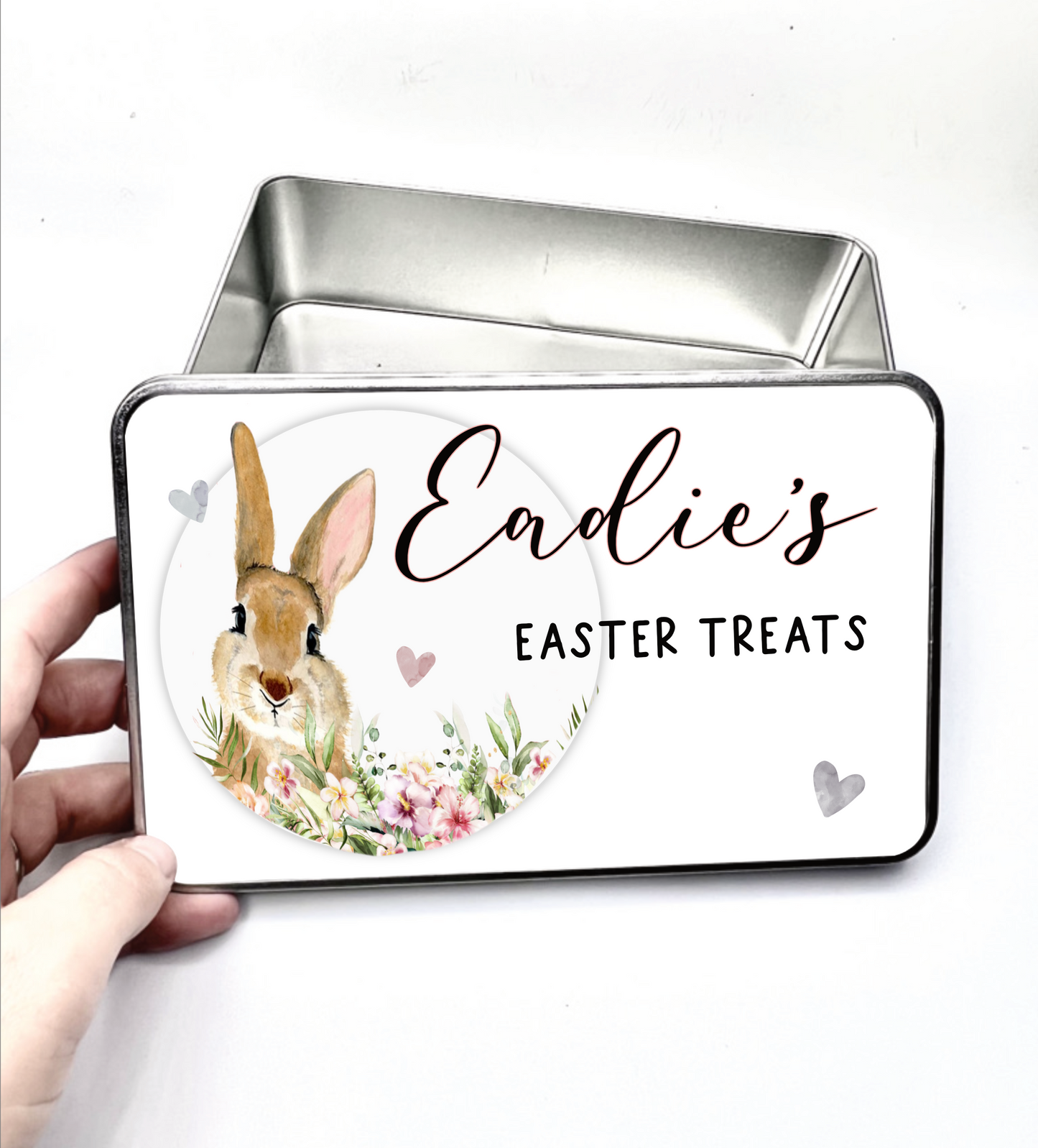 Silver tin with a white push down lid featuring a beautiful floral bunny design with hearts & the quote 'name - easter treats'.