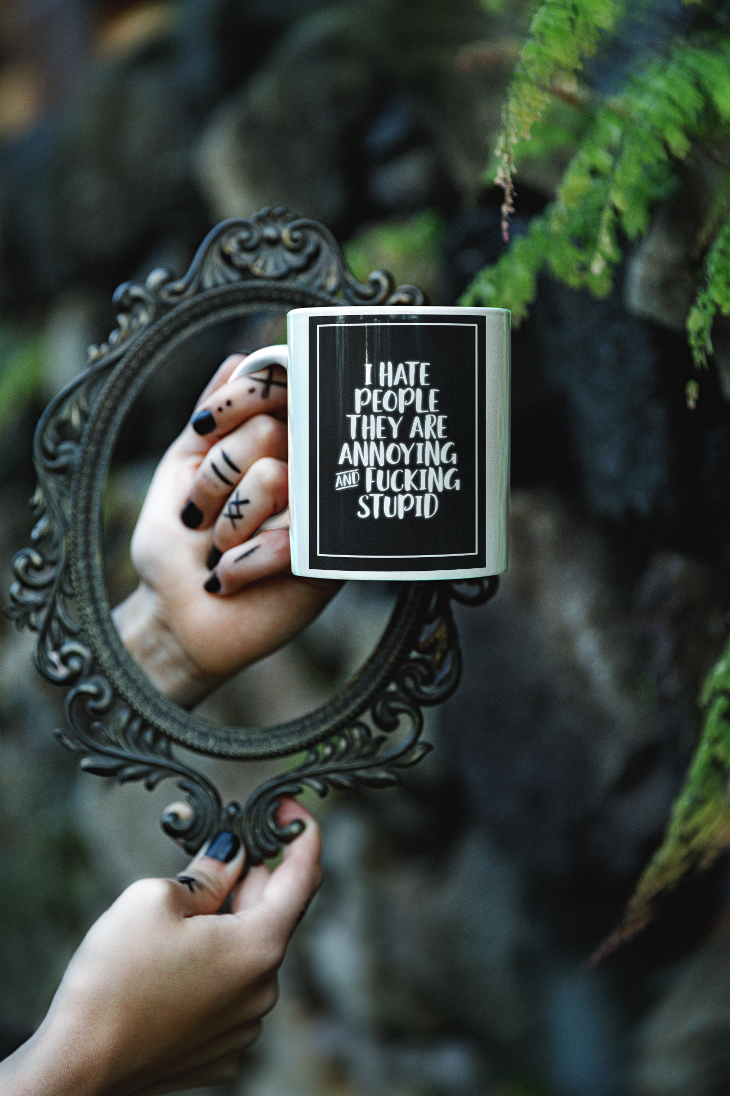 White mug with the quote i hate people they are annoying and fucking stupid printed in white over a black background.
