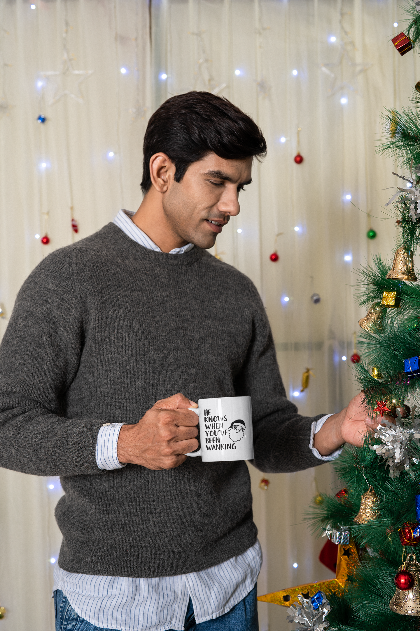 White mug with a cartoon santa head with the words 'he knows when you've been wanking' printed to the left side.