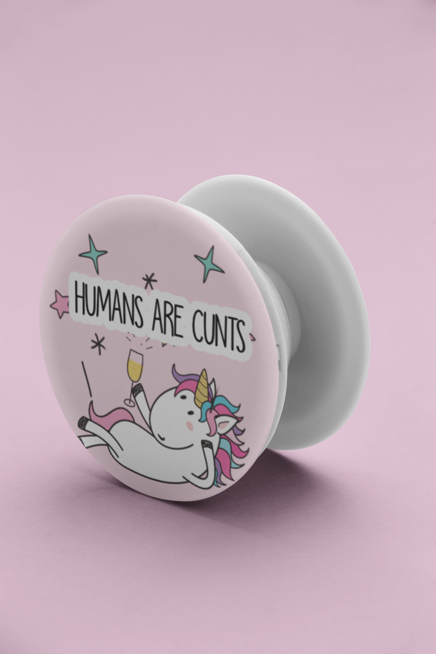 A round phone case popper with a cute stars & unicorn design to the front & the quote 'humans are c*nts' to the top.