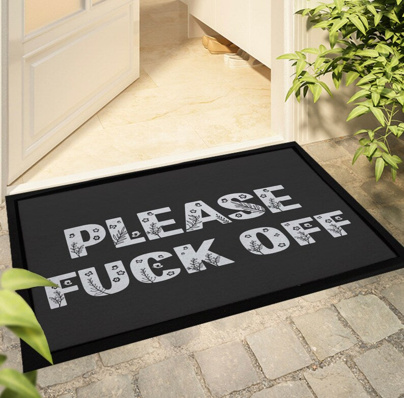 Black indoor, door mat for the home with the quote 'please fuck off' in a floral design font. Non slip. 60x40cm