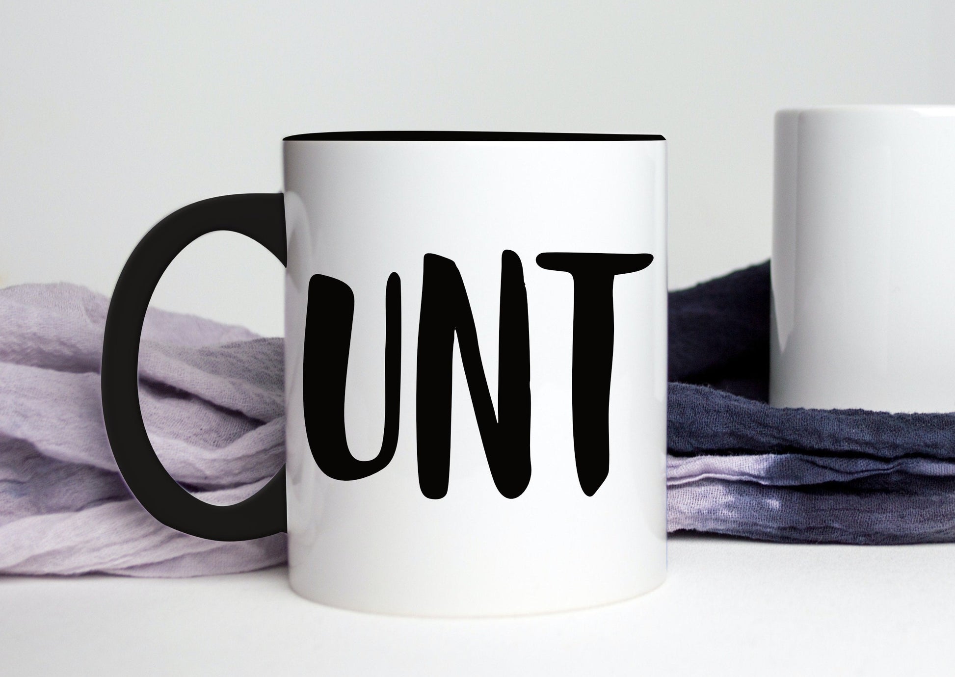 A white ceramic mug with a black handle featuring a funny profanity quote to the front UNT, printed in black ink.