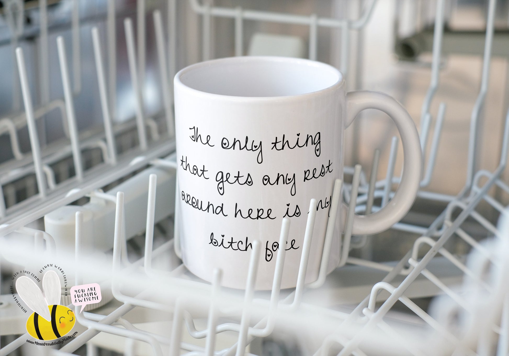 A white ceramic mug featuring the funny quote ‘ The only thing that gets any rest around here is my bitch face’. Printed in black ink.