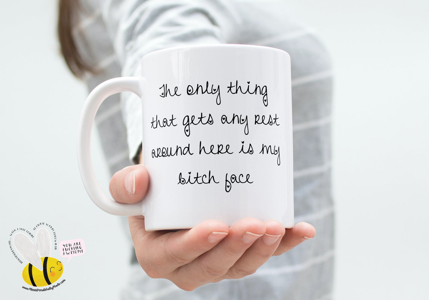 A white ceramic mug featuring the funny quote ‘ The only thing that gets any rest around here is my bitch face’. Printed in black ink.