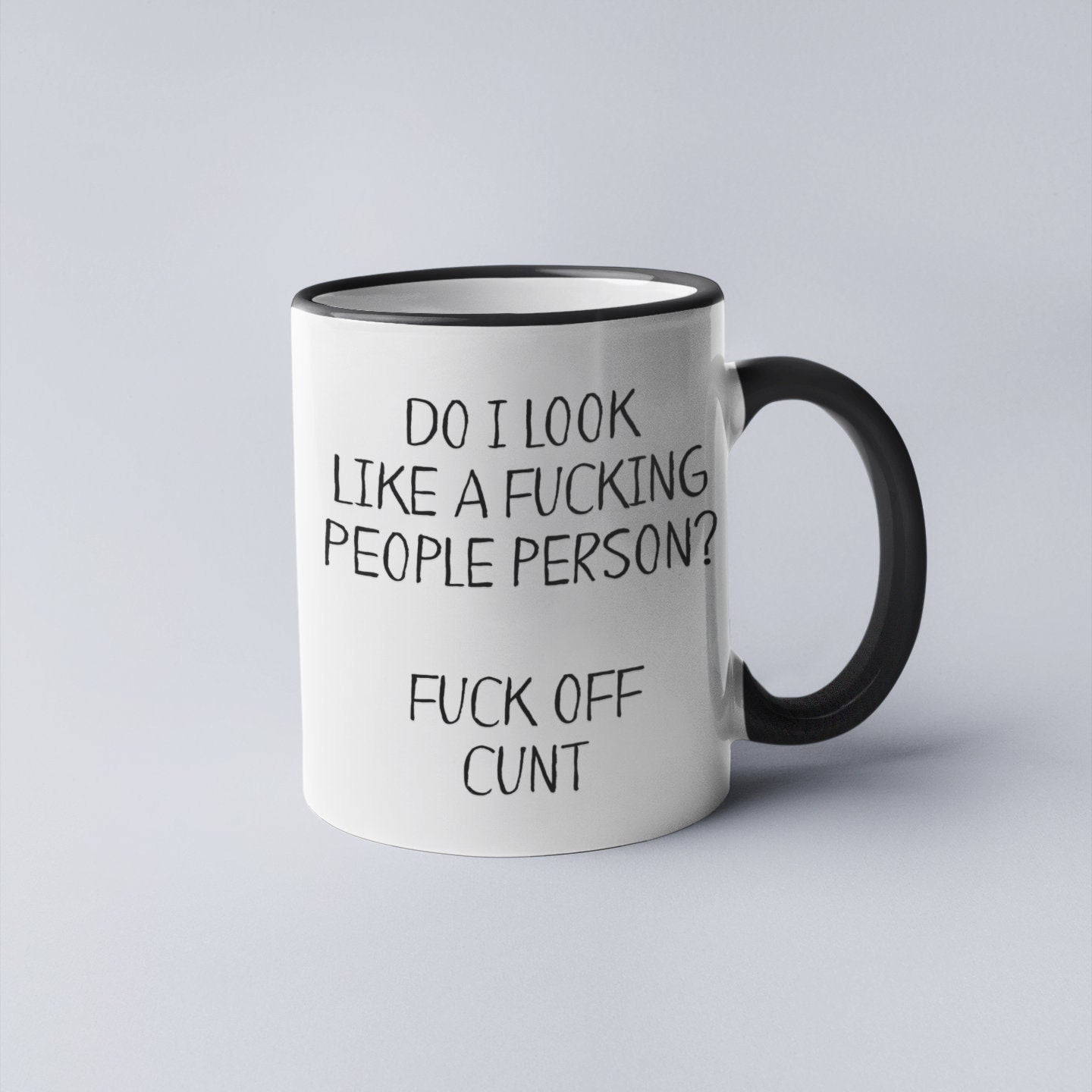 A white ceramic mug featuring the funny quote ‘do i look like a fucking people person? Fuck off c*nt’. Printed in black ink.