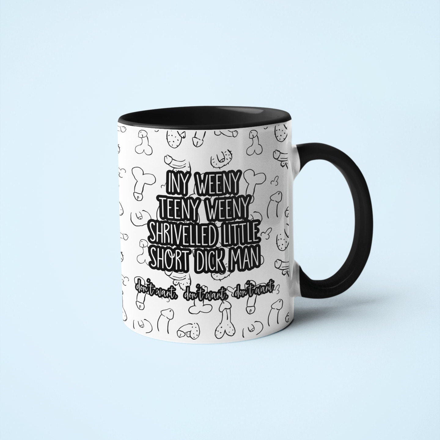White mug with a black handle and rim, with a funny willy design printed throughout. Over the print it reads iny weeny teeny weeny shrivelled little short dick man.. don't want, don't want, don't want.