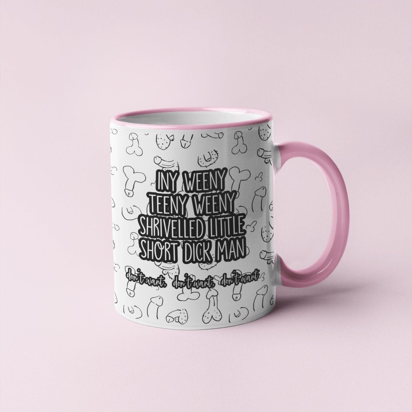 White mug with a pink handle and rim, with a funny willy design printed throughout. Over the print it reads iny weeny teeny weeny shrivelled little short dick man.. don't want, don't want, don't want.