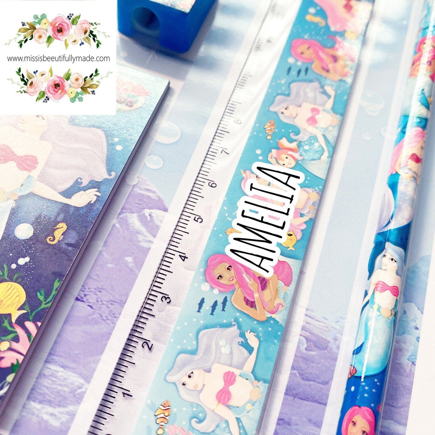 Personalised Children's stationery set in a mermaid, under the sea design. The contents are, rubber, sharpener, notepad, ruler & pencil. All complete on a personalised backing card. The ruler is also personalised with Childs name.