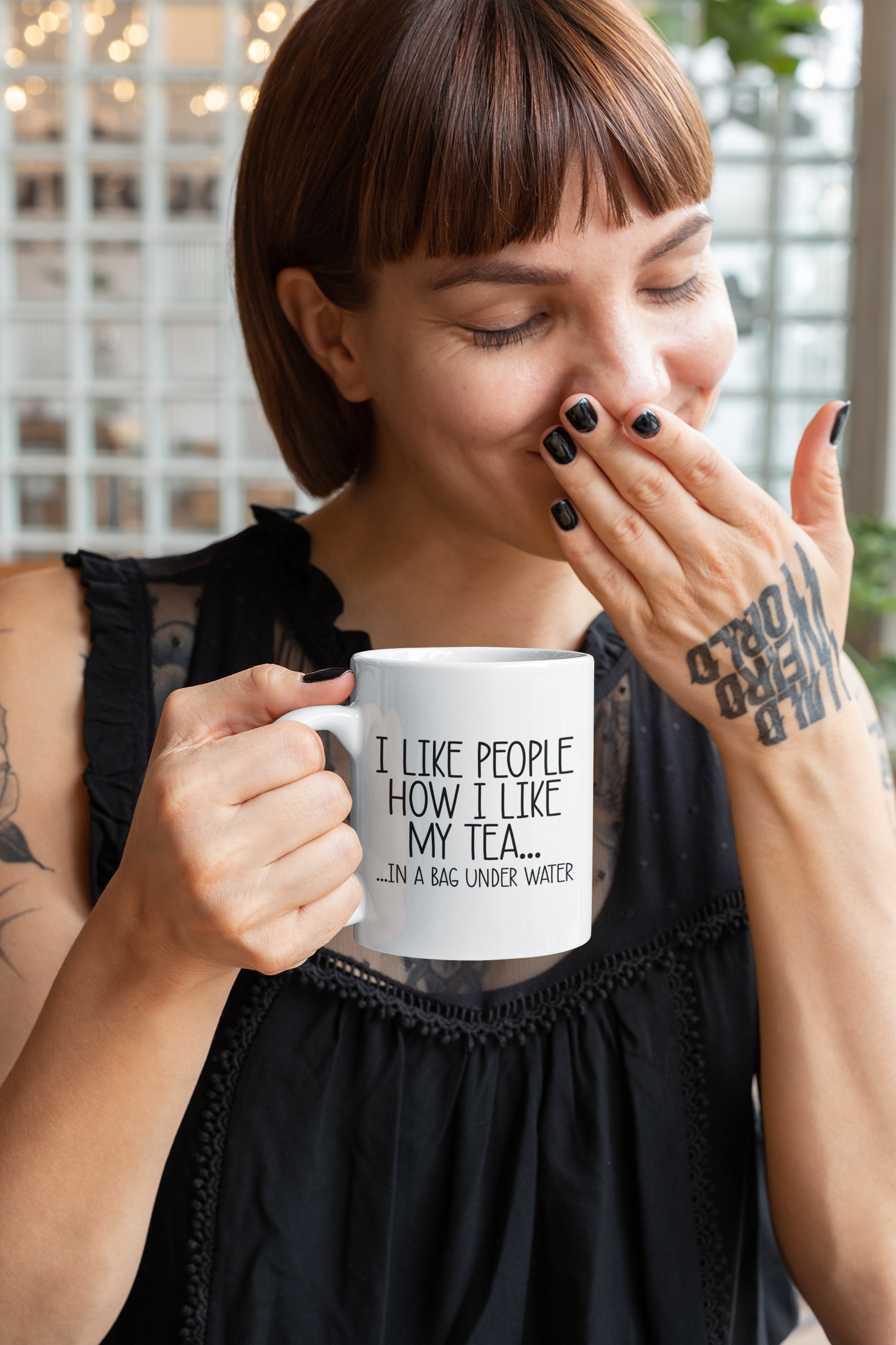 White mug with the quote i like people how i like my tea... in a bag under water. Printed in black