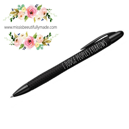 black ballpoint pen with black in and white printed quote saying 'I judge peoples eyebrows'. 