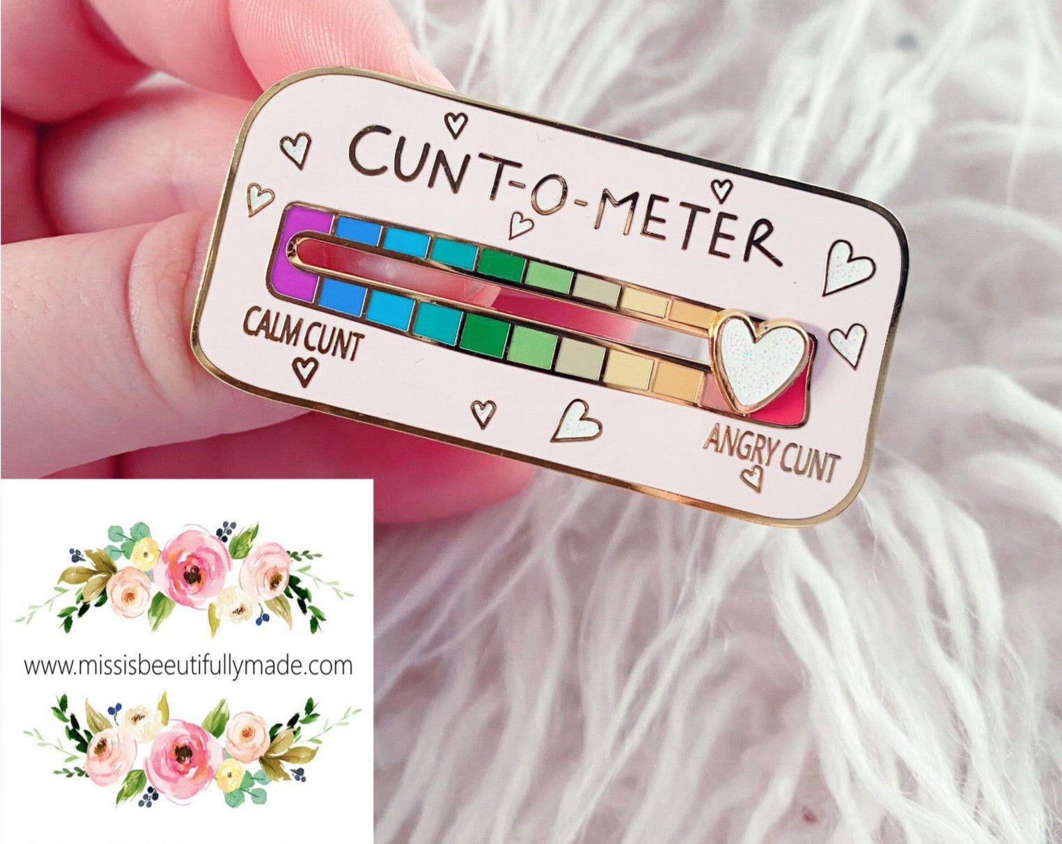Gold enamel cunt-o-meter pin badge with a white glittery sliding heart. Slide from calm cunt to angry cunt with this funny interactive pin badge with pretty pastel rainbow colours.