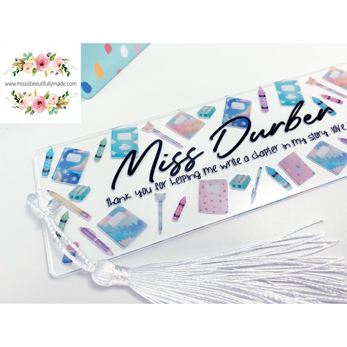 Clear Acrylic bookmark, personalised with child's and teachers name. Has a beautiful stationery design to the front and a white tassel to finish it off. Printed direct to the acrylic.