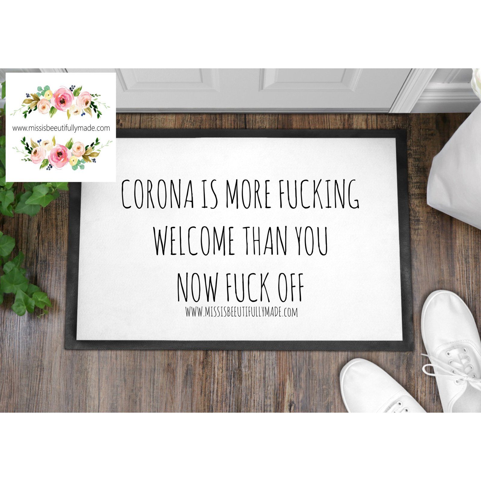 White non slip door mat with a rubber backing. The front is white with a black printed design saying corona is more fucking welcome than you now fuck off. measure 40x60cm.