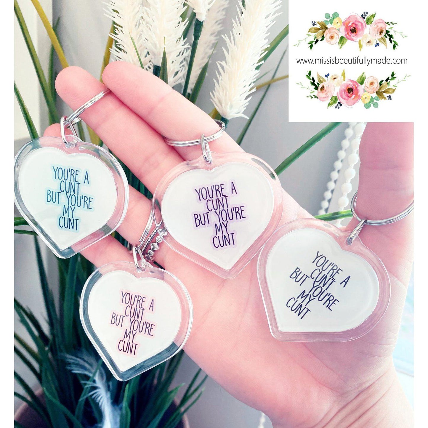 4 Acrylic heart keyrings featuring the funny design 'you're a c*nt, but you'r my c*nt', printed in blue, purple, pink & white.