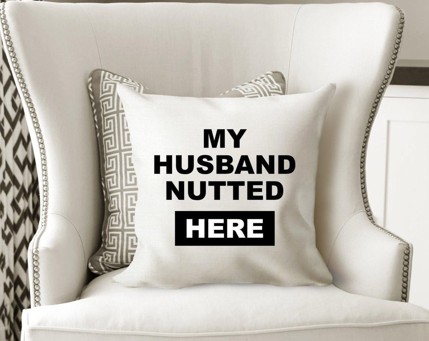 White cushion cover with the funny quote 'my husband nutted here'. Cover only, Zip fastener and printed one side
