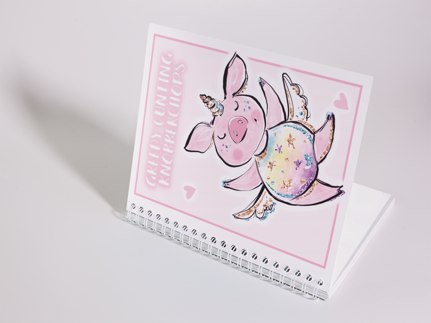 A5 food diary with daily food log pages containing sections for snacks, exercise & water intake. The cover features a fun pink design with a unicorn pig & a quote to the top which reads 'greedy cunting knobberchops'. 