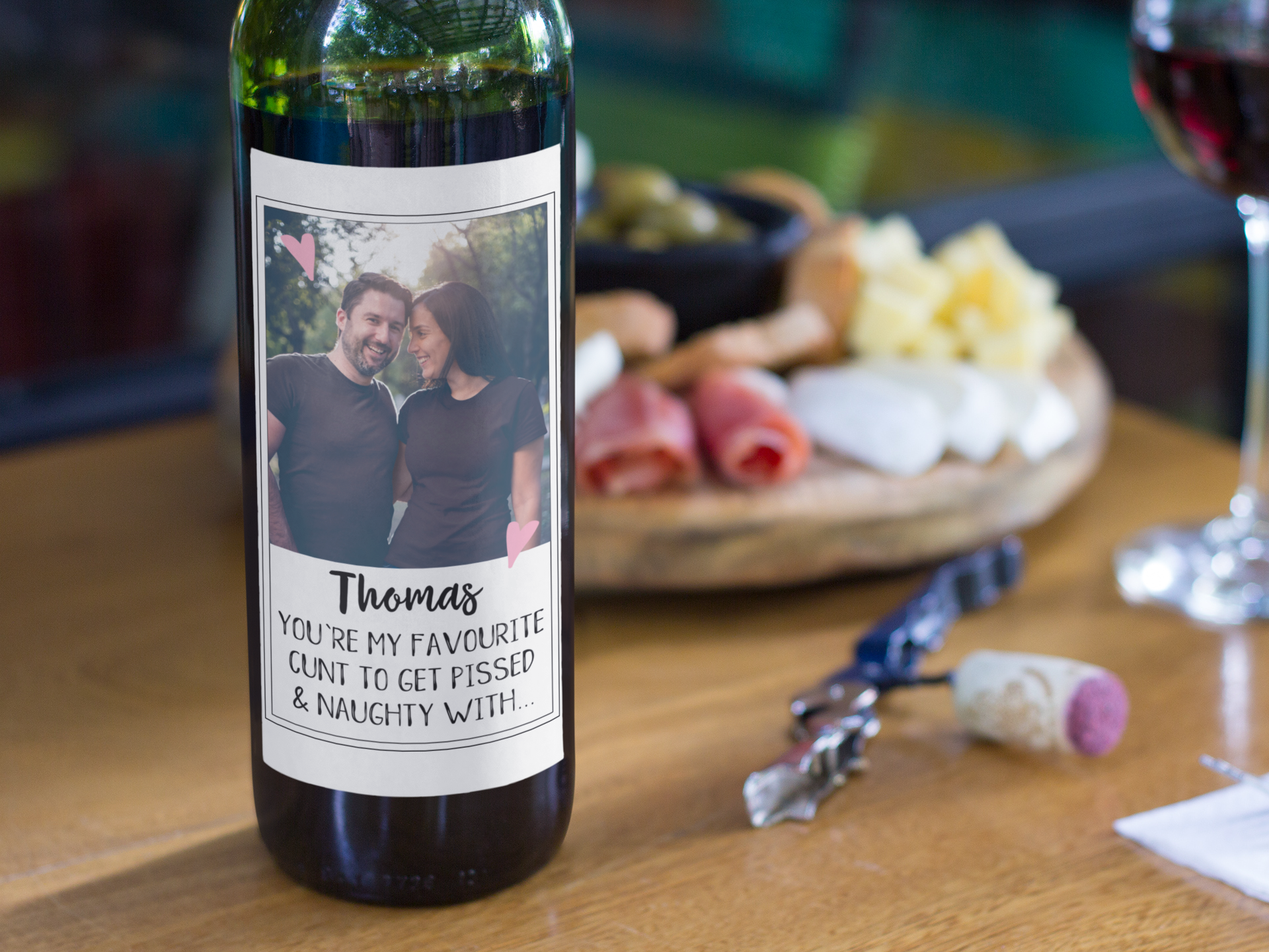 Wine bottle featuring a personalised label of a photo of couple & a funny quote underneath which reads '(name), you're my favourite cunt to get pissed & naughty with'.