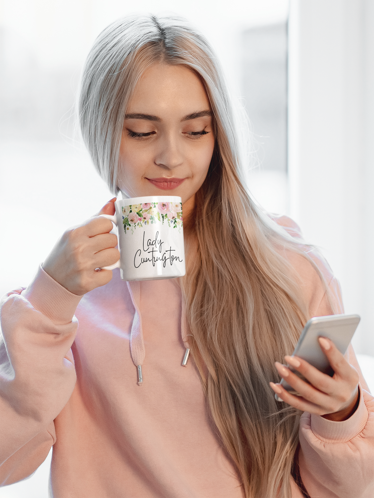 White mug with a colourful floral border to the top. Underneath is the quote lady cuntington in black ink.