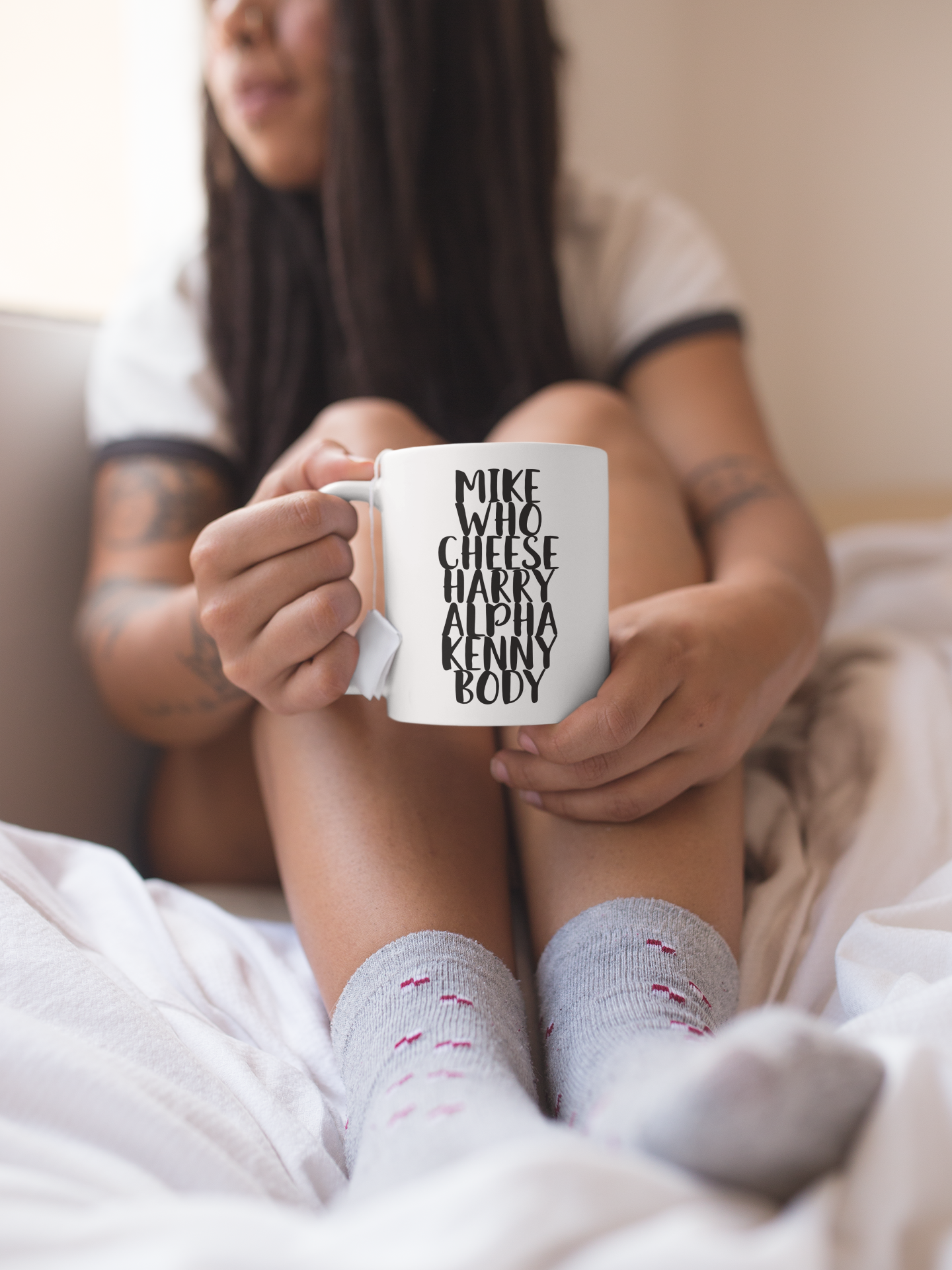 White mug with the quote mike who cheese alpha kenny body printed down the middle in black ink.