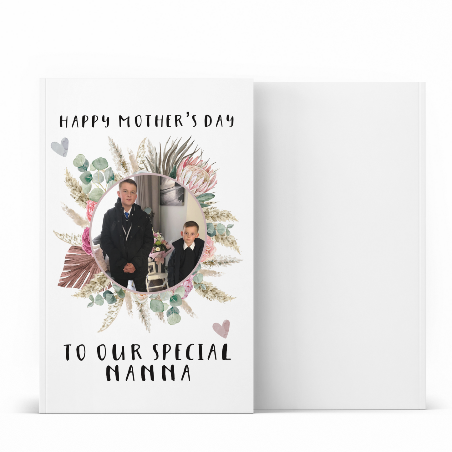 A white notebook which has a colourful floral design wreath with a personalised photo of 2 children in the middle. To the top of the flower is the words 'happy mother's day.' and to the bottom 'to our special nanna' Printed in black ink.