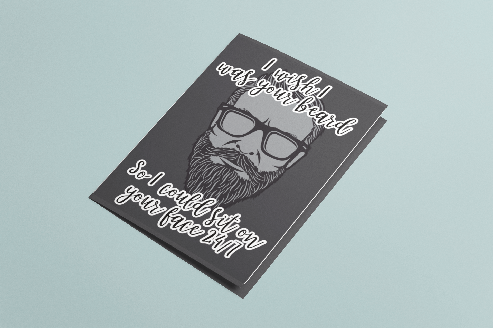 Hand holding a black vertical card featuring a clipart of a beard. To the top is the quote 'i wish i was your beard' and to the bottom ' so i could sit on your face 24/7. Printed in white.