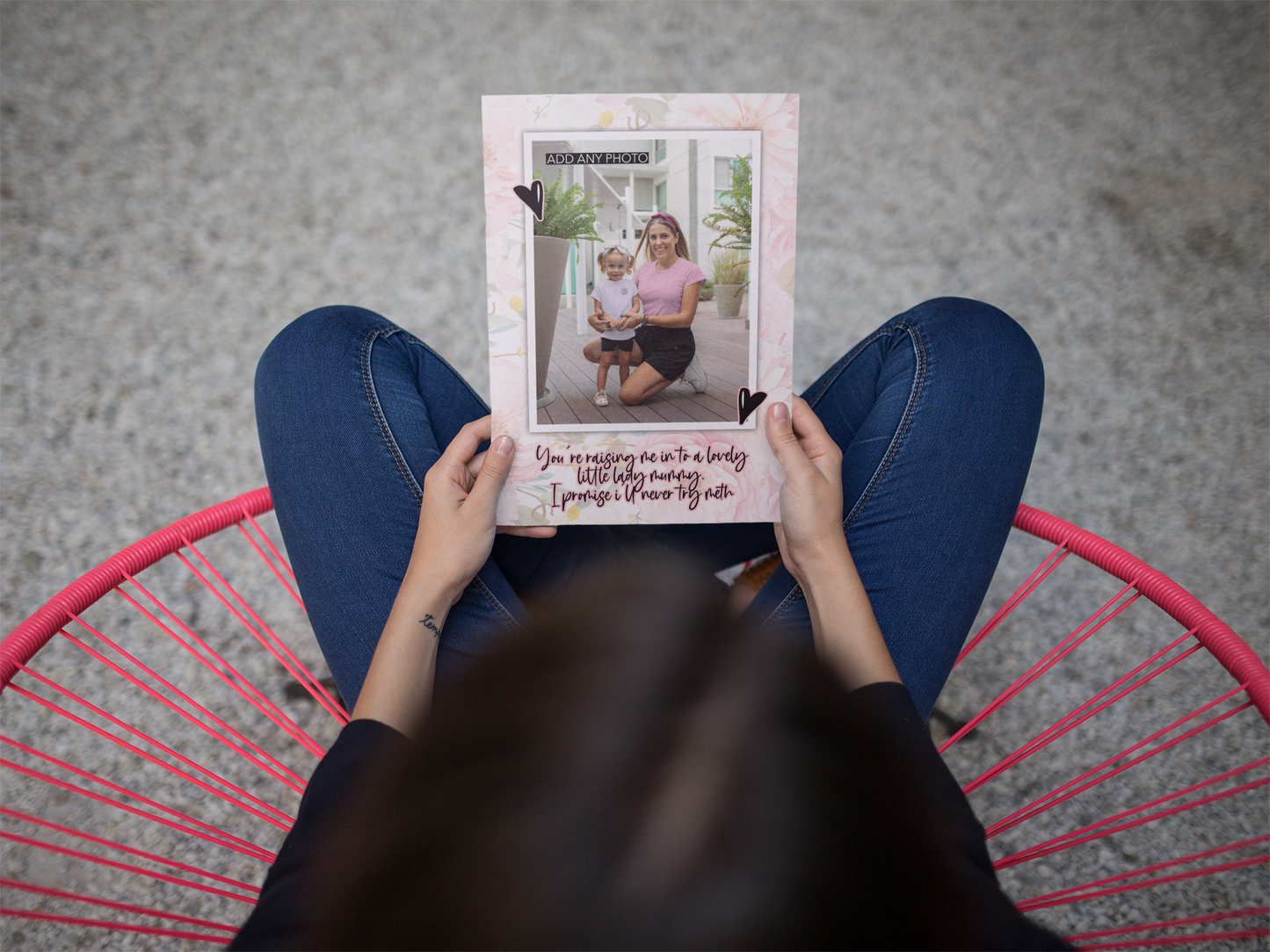 Floral greetings card with a personalised photo inside a white frame, situated to the front. Two black hearts for decoration around the frame and a quote underneath which reads 'you're raising me in to a lovely little lady, mummy. I promise i'll never try meth'. Printed in black ink with a rose colour outline.