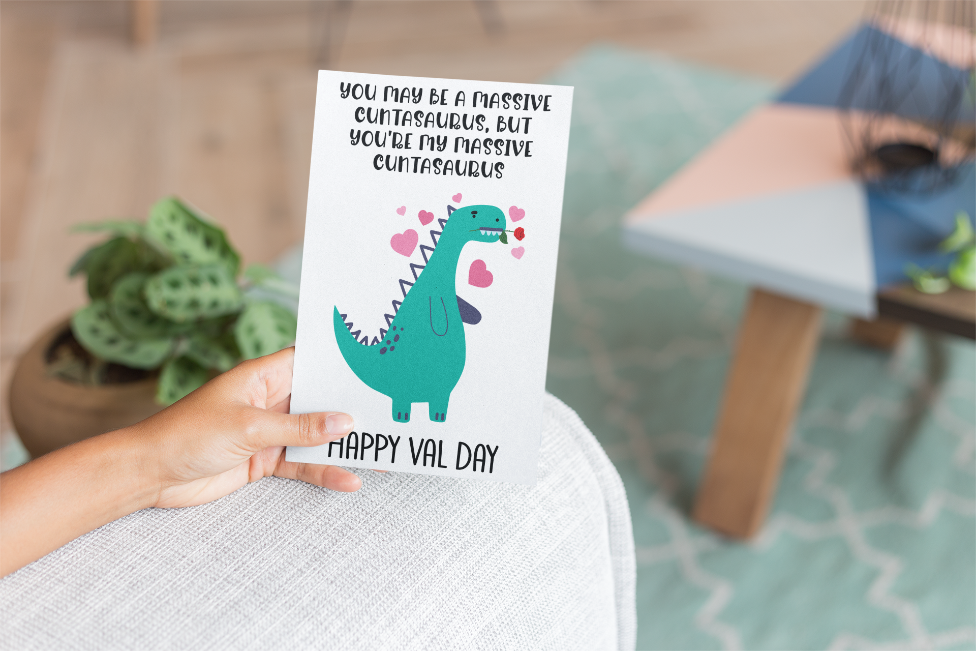 A5 glossy white card with a valentines dinosaur design to the front. The quote reads 'you may be a massive cuntasaurus, but you're my massive cuntasaurus'. With happy val day situated at the bottom. The inside is left blank.