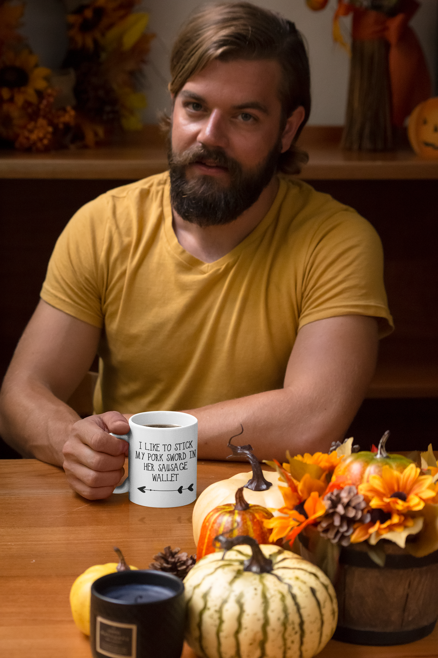 Man holding a white mug with a funny quote reading 'i like to stick my pork sword in her sausage wallet' with an arrow underneath, pointing to the left. Printed in black ink.