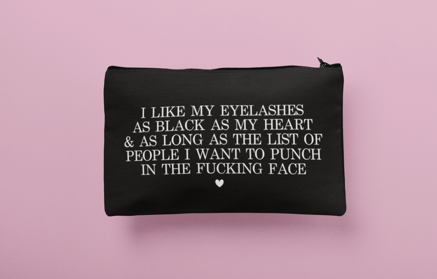 Black cosmetic bag featuring a funny quote in a bold text which reads 'i like my eyelashes as black as my heart & as long as the list of people i want to punch in the fucking face.' Printed in white.