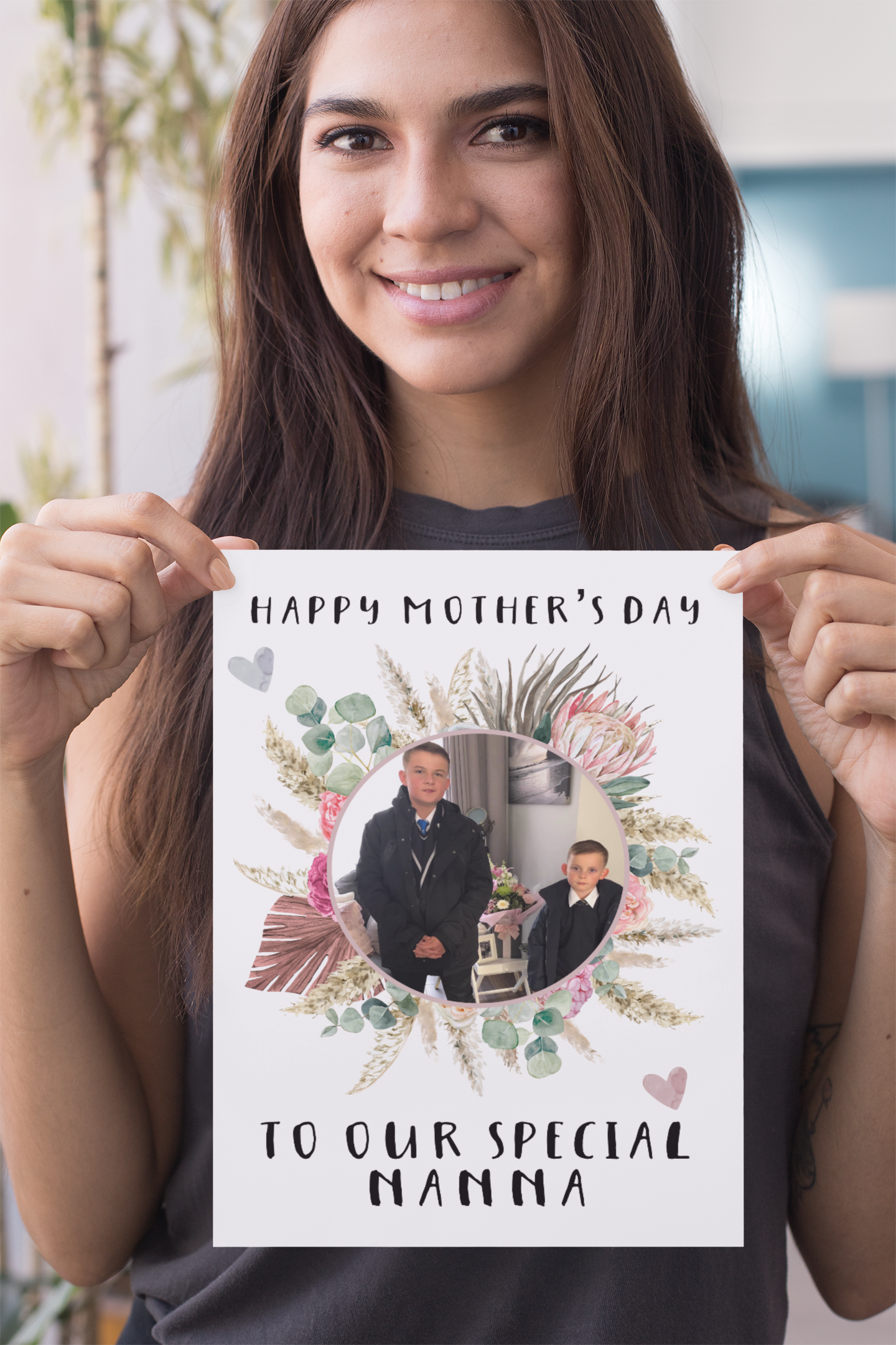 A white greetings card which has a colourful floral design wreath with a personalised photo of 2 children in the middle. To the top of the flower is the words 'happy mother's day.' and to the bottom 'to our special nanna' Printed in black ink.