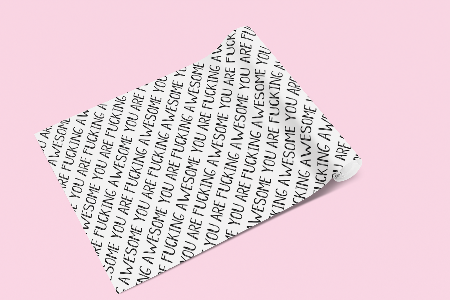 A roll of gift wrap laid out on to a pink surface. Features a funny repetitive quote 'you are fucking awesome' in black ink.