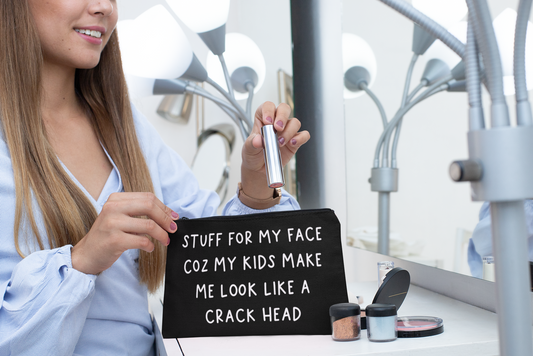 Black canvas make up bag with white lettering to the front featuring the funny quote 'stuff for my face coz my kids make me look like a crack head'. 
